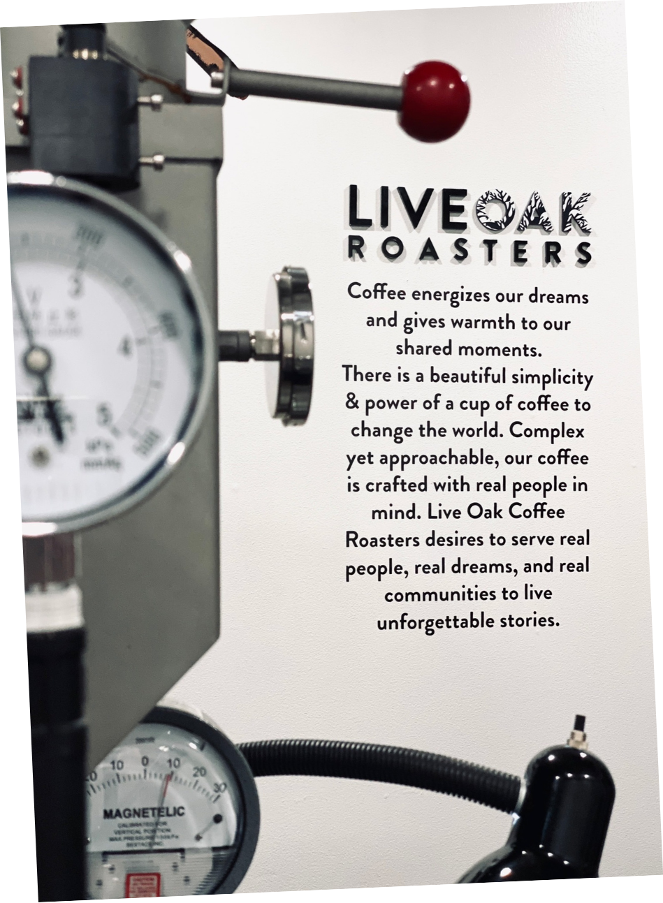 Coffee roaster gauges beside the Live Oak Roasters creed on the roastery wall